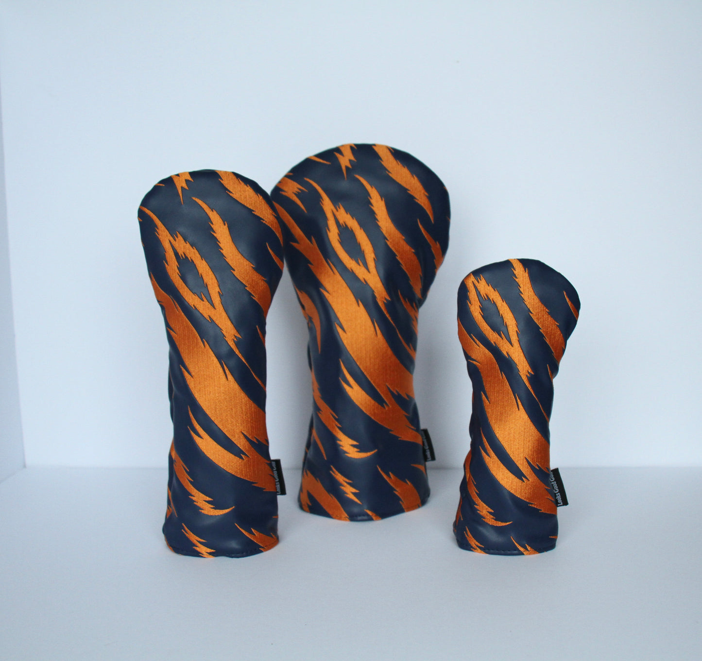 Navy and orange tiger stripe golf headcover set close-up – driver, fairway wood, hybrid by Looks Good Golf