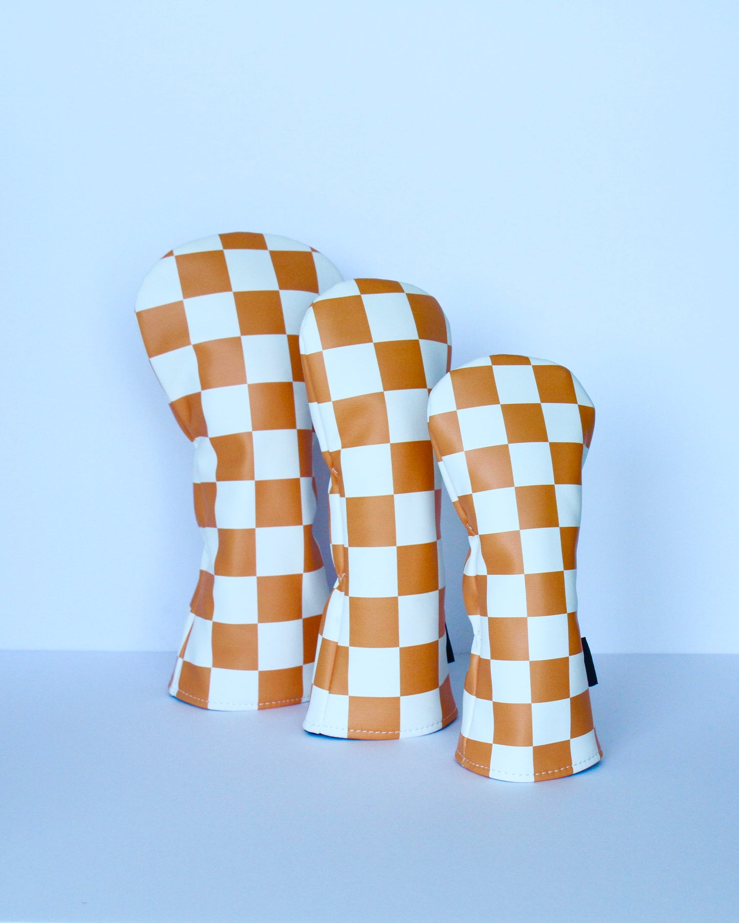 Orange and white checkerboard golf headcover 3-piece set angled view by Looks Good Golf